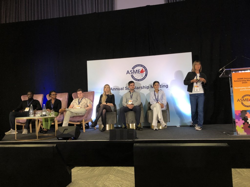 Prof Sally Curtis presents a keynote speech at the ASME conference, accompanied on stage by six students